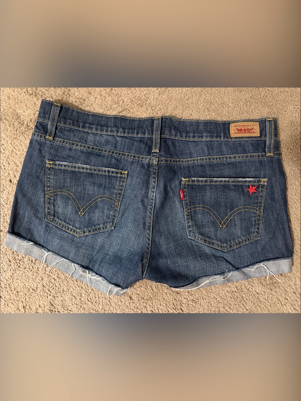 Vintage Levi's Dark Blue Denim Cutoff Shorts with Red Star Detail, size 9.